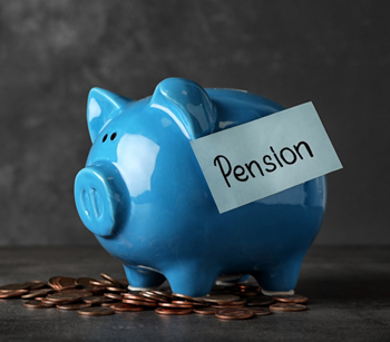 Piggy bank with word PENSION and coins on table. Space for text