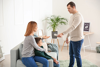 man giving money to spouse